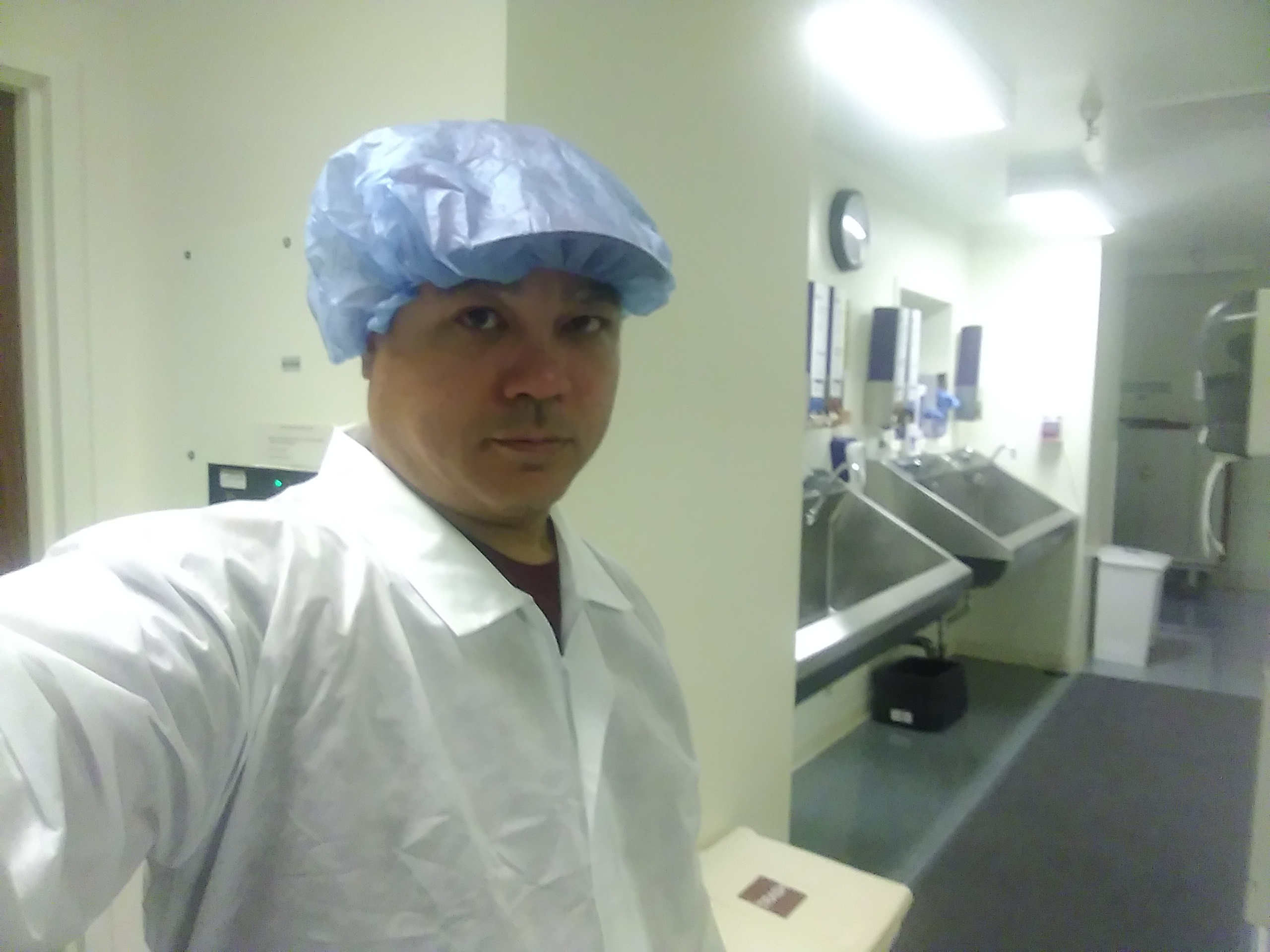 Isolated Power System technician in surgical attire at a hospital operating-room scrub area